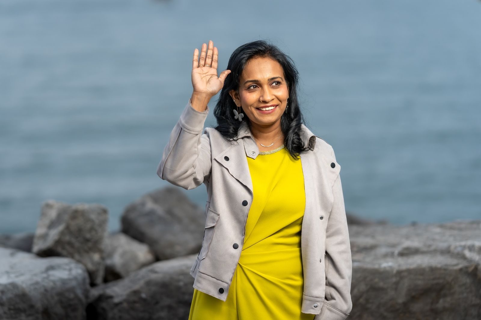 Sharmina Nasrin waving by the water